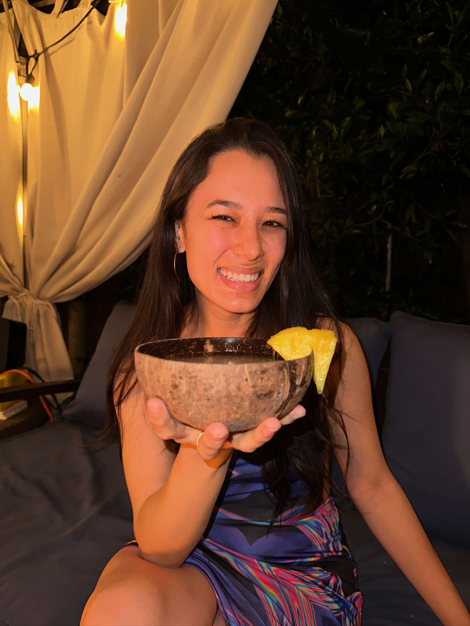 a Photograph of Kavahana Holding a Coconut Shell at Night   Kavahana