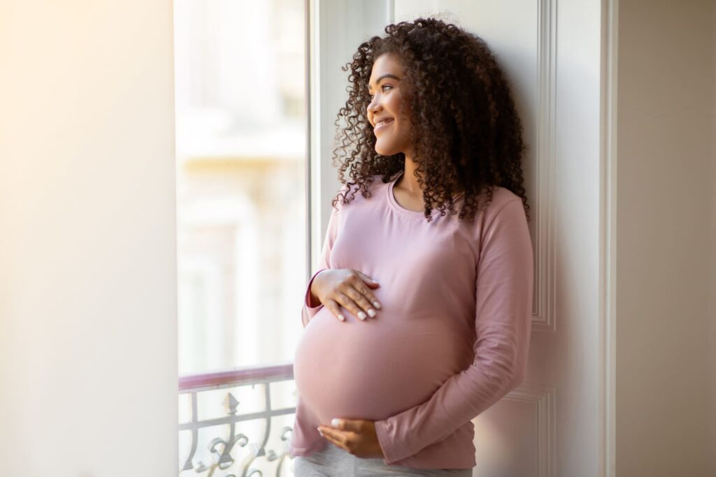 Pregnant Woman with Hands on Belly Kavahana Kavahana