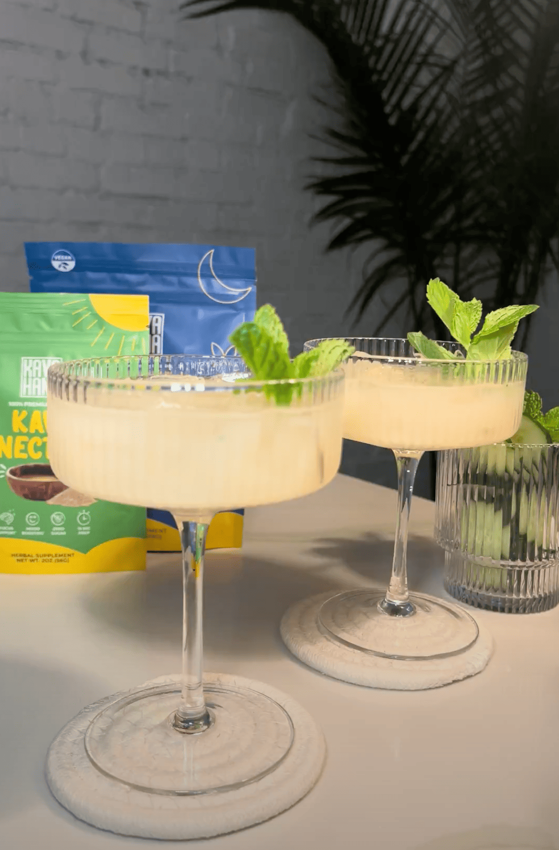 Kava Cocktails in Fancy Glasses with Green Garnish and Kava Nectar in the Background   Kavahana