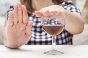 Woman with Checkered Shirt Covering Whiskey Glass Kavahana