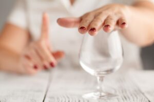 Woman with Red Nails Covering Wine Glass Kavahana